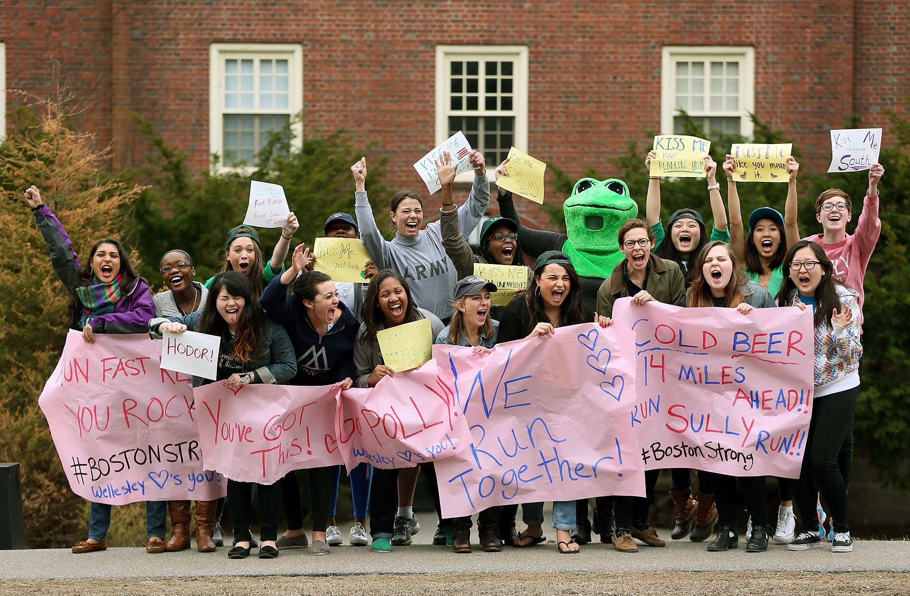 Students from Wellesley College cheer Boston marathon runners. 
