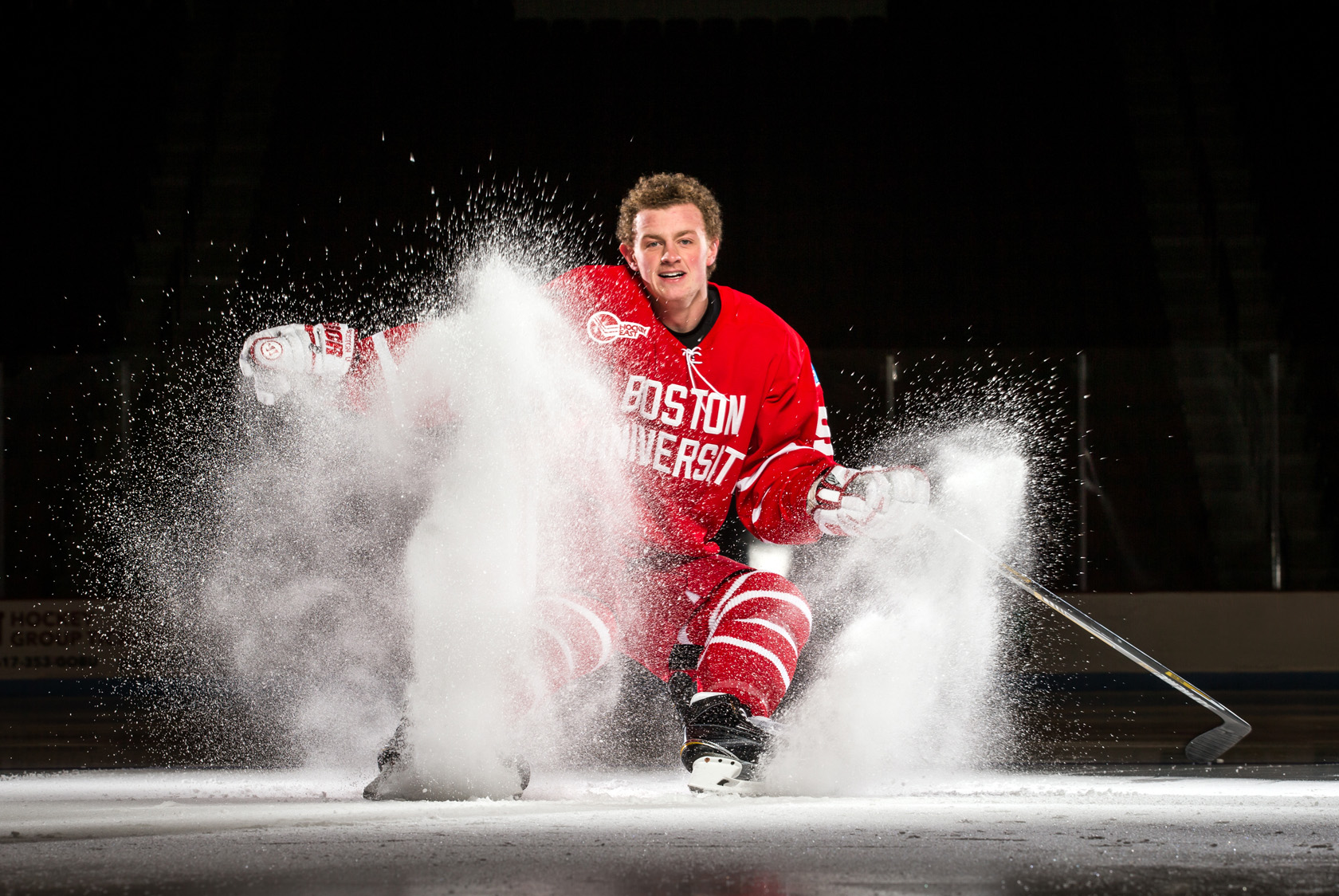 Boston University hockey player Jack Eichel hockey stops  spray for a portrait.