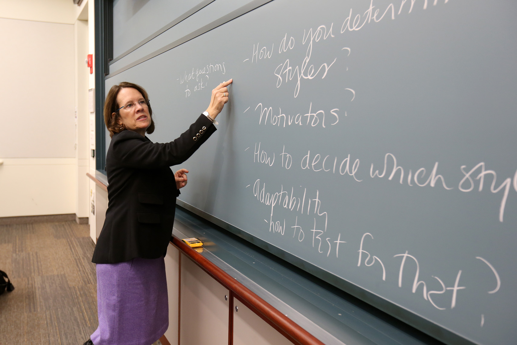 A professor uses the chalkboard to define a lesson during a class at Boston Univ.