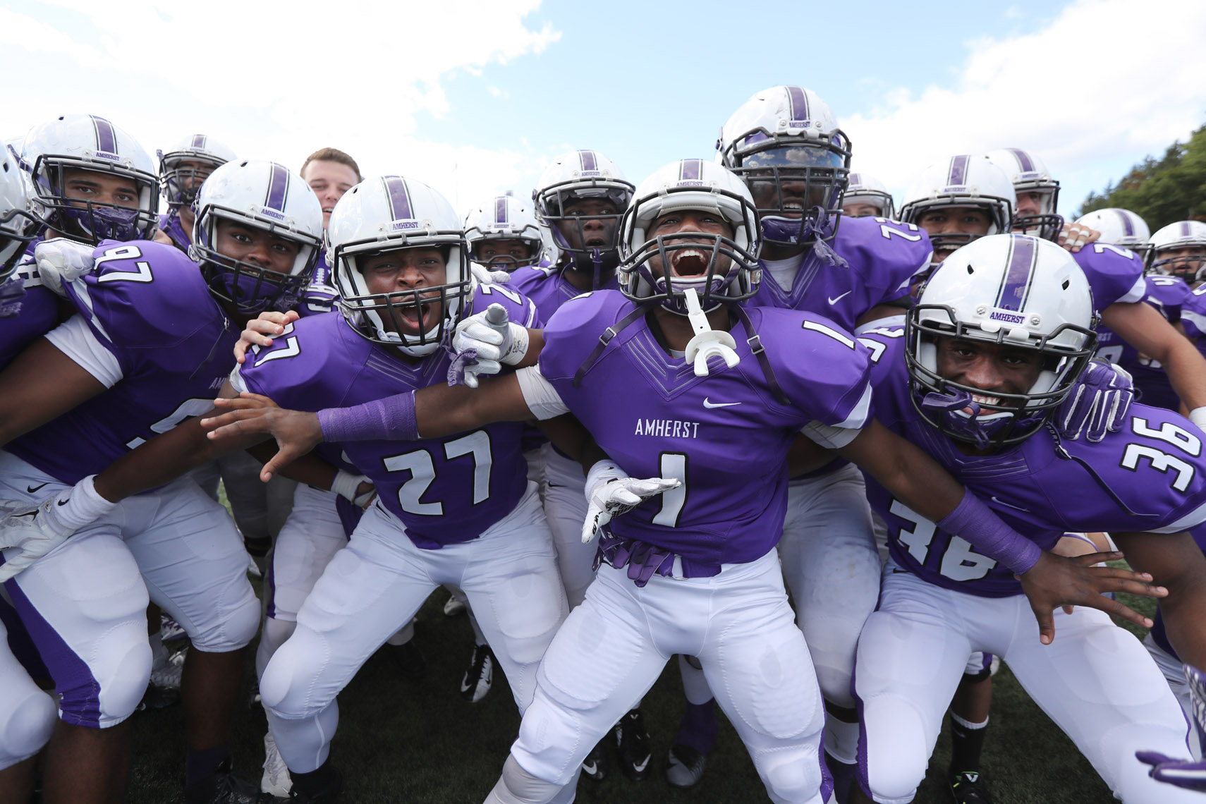 Amherst College football players celebrate a victory over Hamilton.