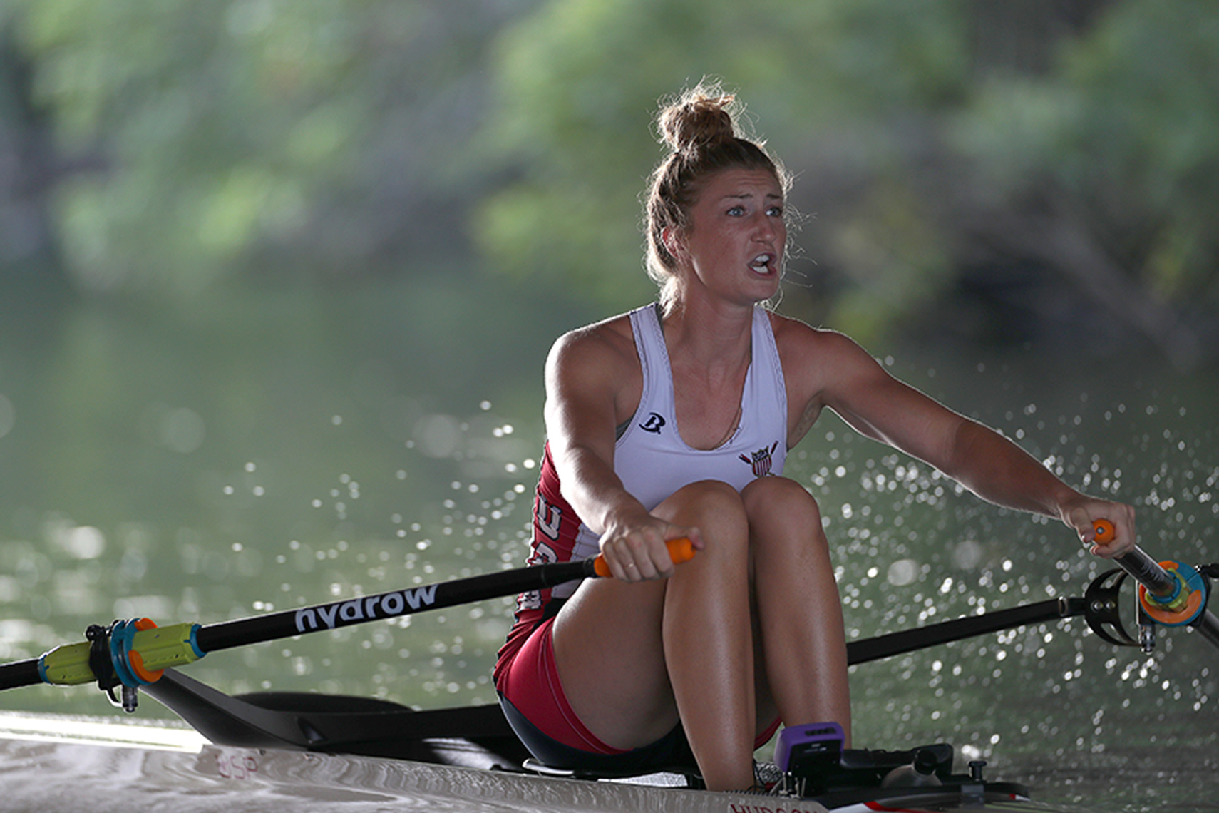 A rower makes her way down the Charles River in early morning light.