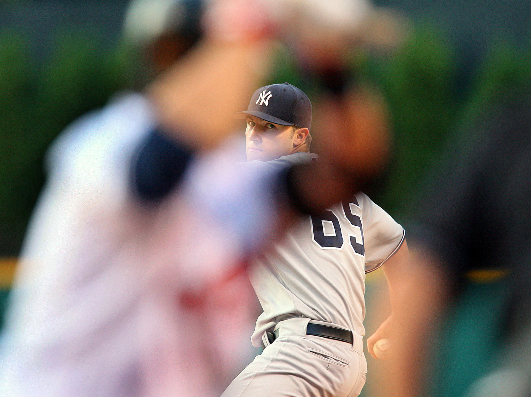  Yankee pitcher Phillip Hughes is framed by the batter during a game in Cleveland.
