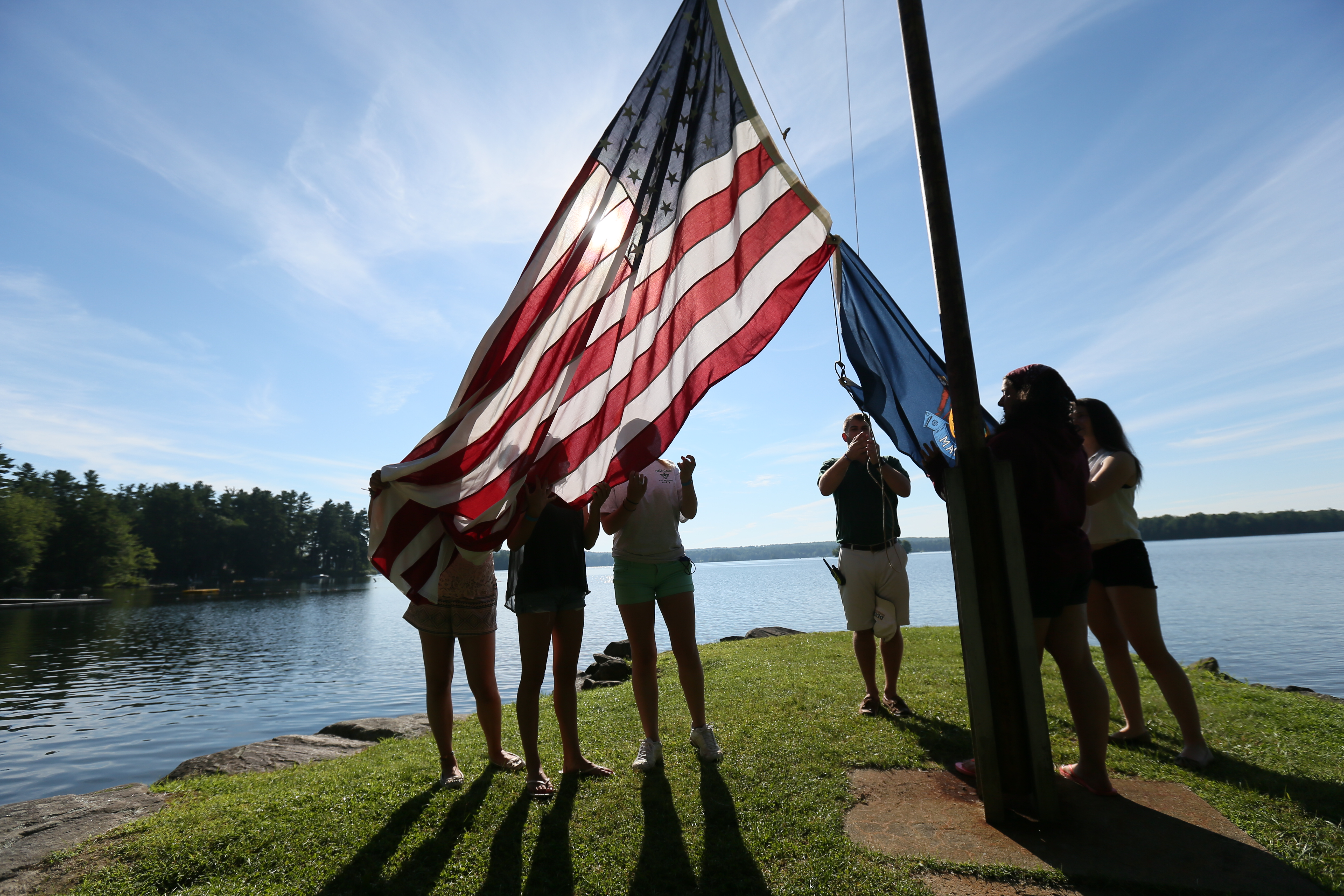  YMCA of Maine summer campers  raise the flag to begin the day in Winthrop, ME.