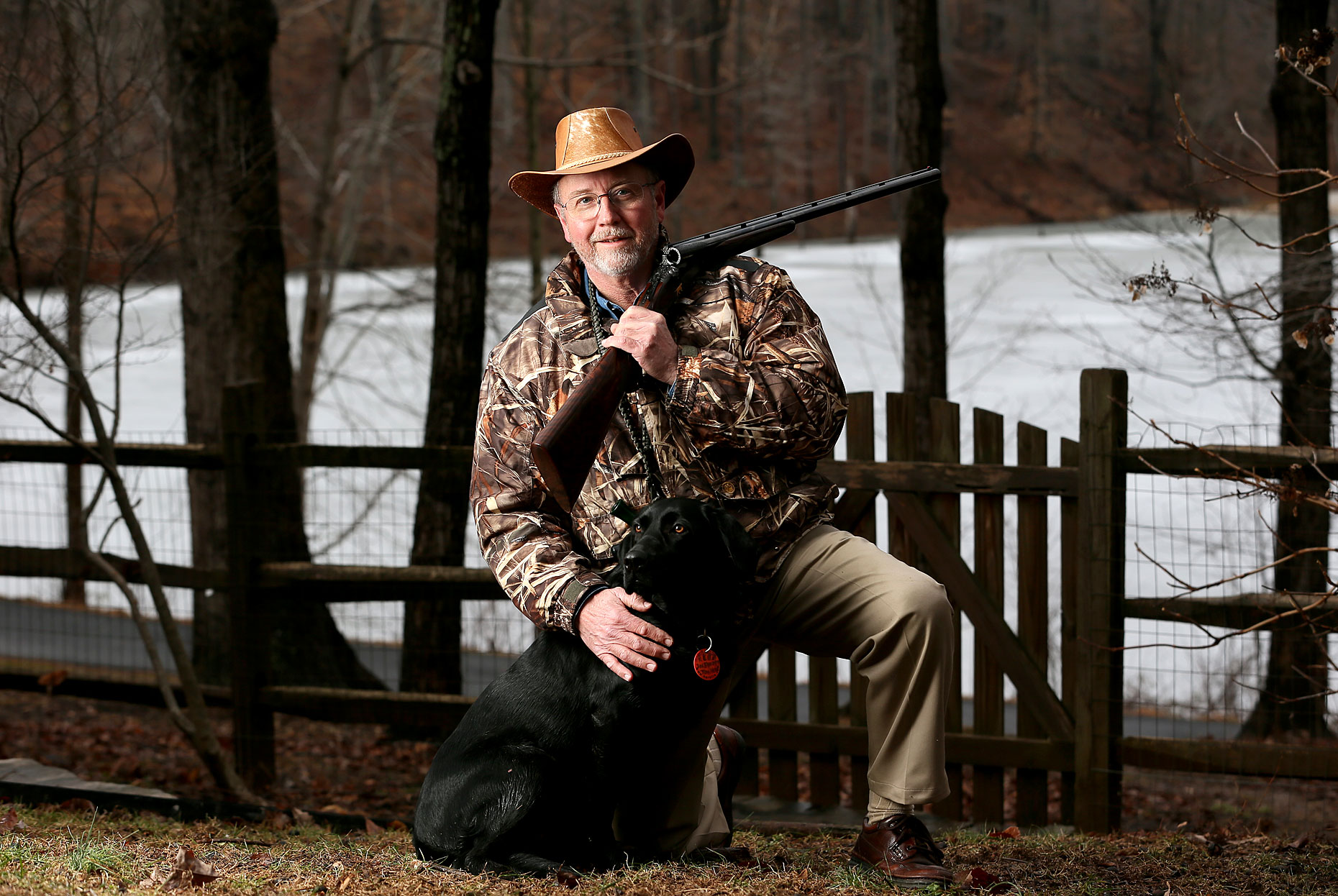 Tom Held poses with his Black Labrador and shotgun during a portrait shoot.