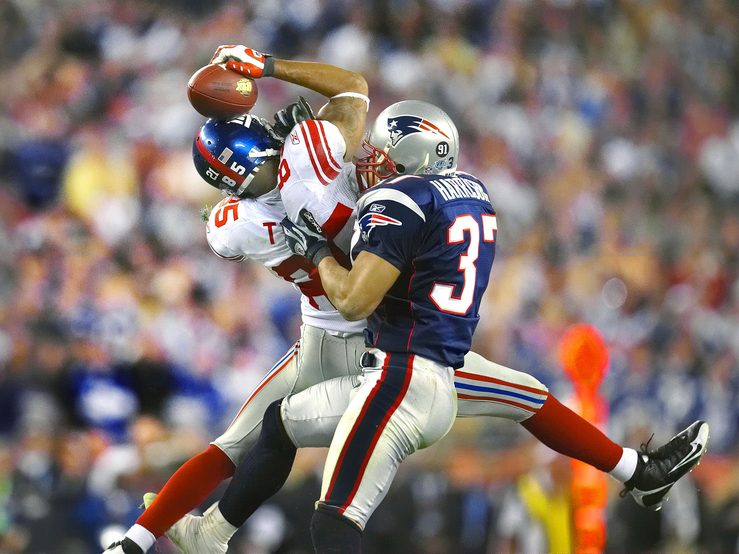 NY Giants receiver David Tyree makes a catch by trapping the ball on his helmet.